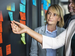 business people planning tasks with sticky notes